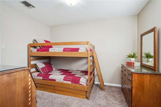 bedroom featuring light carpet, visible vents, and baseboards