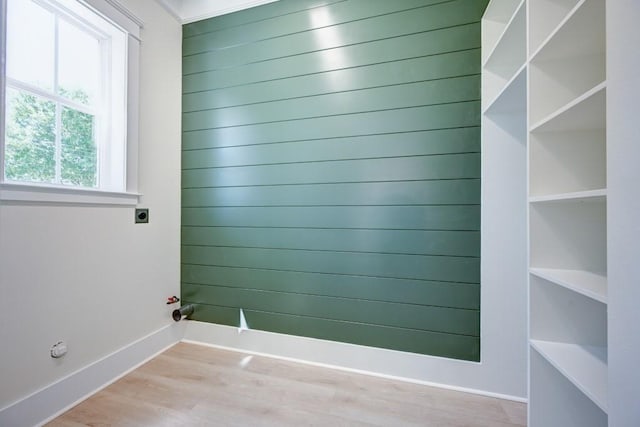empty room featuring baseboards and wood finished floors