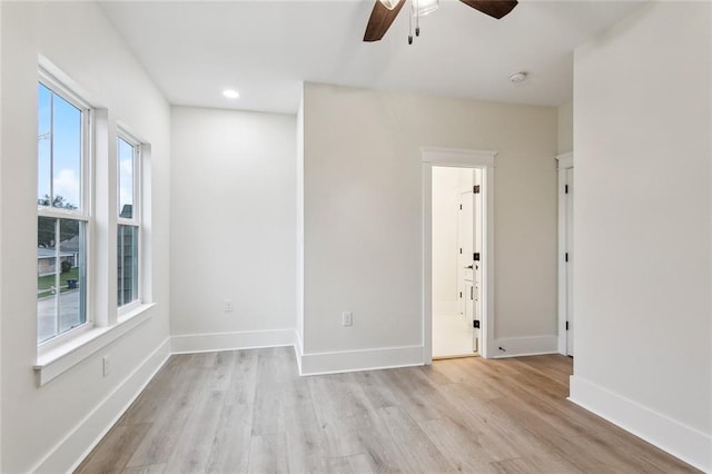 spare room with recessed lighting, light wood-style flooring, baseboards, and a ceiling fan