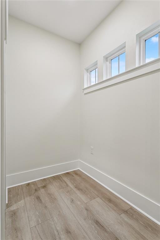 unfurnished room featuring wood finished floors and baseboards