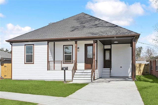 bungalow-style home with a porch, roof with shingles, fence, and a front lawn