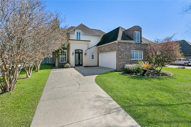 french country home with a garage, driveway, a front lawn, and brick siding