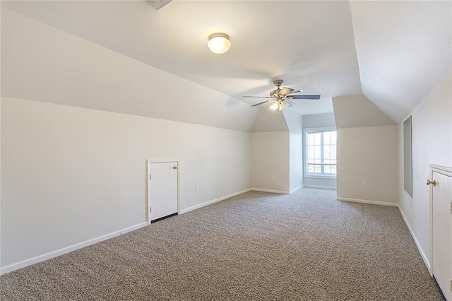 bonus room featuring ceiling fan, baseboards, vaulted ceiling, and carpet flooring