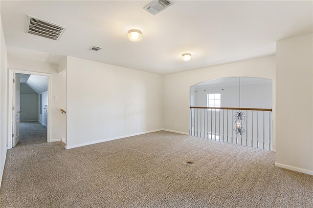 carpeted empty room with visible vents and baseboards