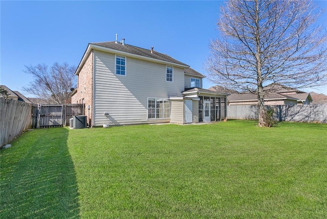 back of house with central AC unit, a lawn, a fenced backyard, and a sunroom