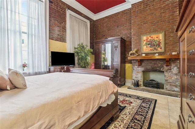 bedroom featuring crown molding, a stone fireplace, brick wall, and light tile patterned floors