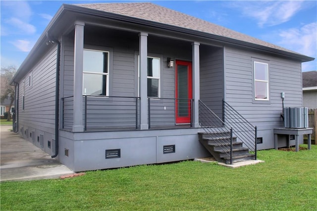 rear view of house featuring a yard, crawl space, cooling unit, and roof with shingles