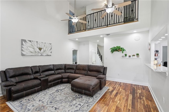 110 Rue Acadian, Belle Chasse, LA 70037 - living area featuring a high ceiling, stairs, baseboards, and wood finished floors
