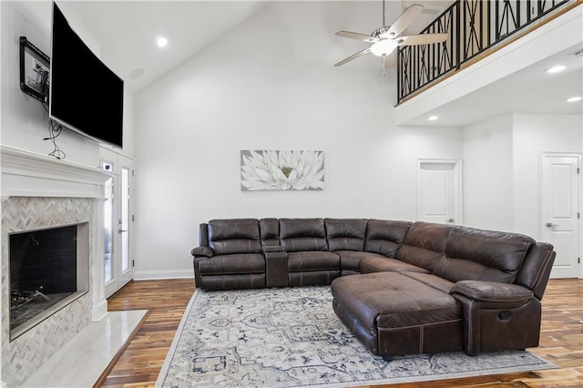 110 Rue Acadian, Belle Chasse, LA 70037 - living area featuring a fireplace, a ceiling fan, wood finished floors, high vaulted ceiling, and baseboards