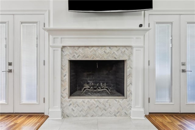 110 Rue Acadian, Belle Chasse, LA 70037 - details featuring wood finished floors, french doors, and a tile fireplace