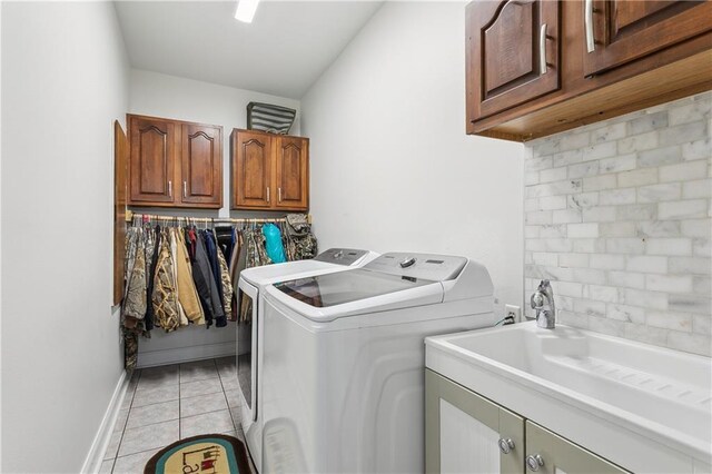 110 Rue Acadian, Belle Chasse, LA 70037 - washroom with washer and clothes dryer, light tile patterned floors, cabinet space, a sink, and baseboards