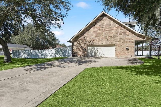110 Rue Acadian, Belle Chasse, LA 70037 - view of side of home with concrete driveway, brick siding, fence, and a lawn