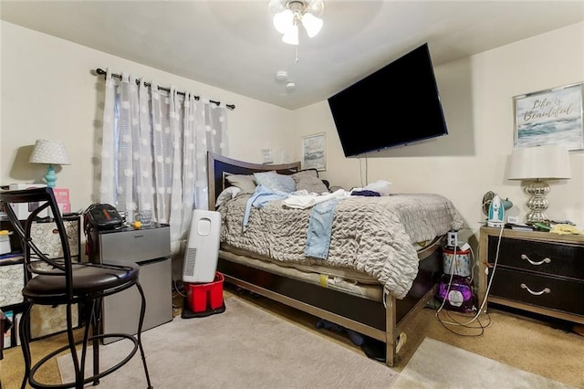 bedroom with light carpet and ceiling fan