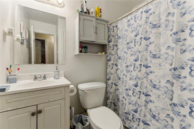 bathroom featuring a shower with curtain, vanity, and toilet