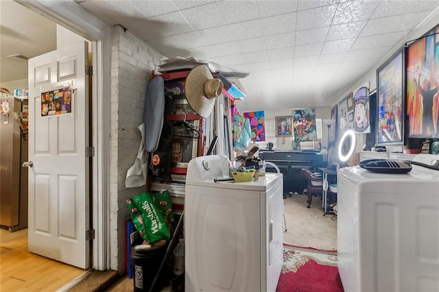 laundry area featuring laundry area, washer and dryer, and wood finished floors