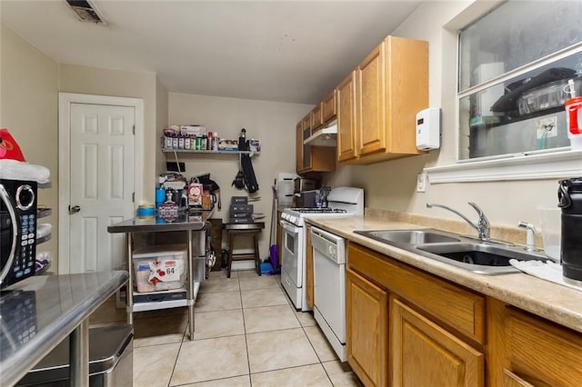 kitchen featuring dishwasher, visible vents, light countertops, and a sink