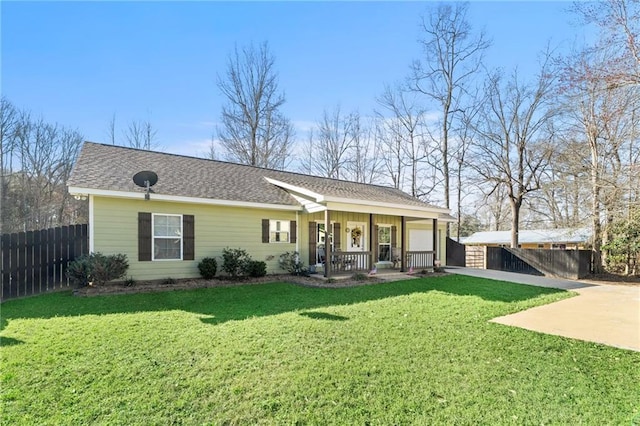 ranch-style house with a front yard, covered porch, an attached garage, and concrete driveway