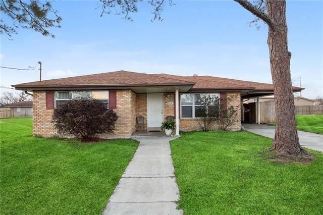 view of front of house with a front yard and fence