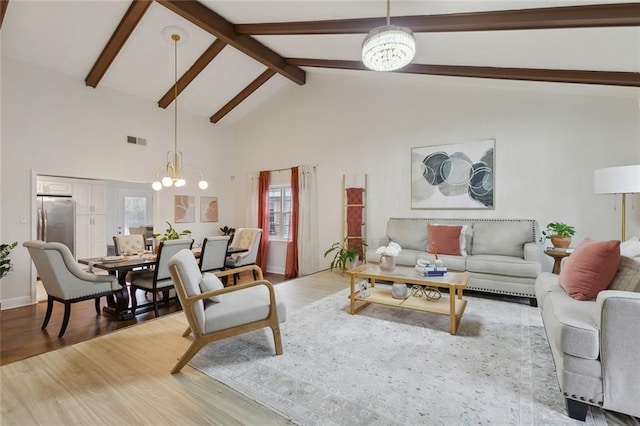 living room with visible vents, a chandelier, wood finished floors, beamed ceiling, and high vaulted ceiling