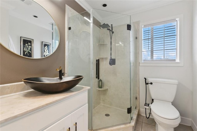 bathroom with crown molding, toilet, a stall shower, vanity, and tile patterned flooring