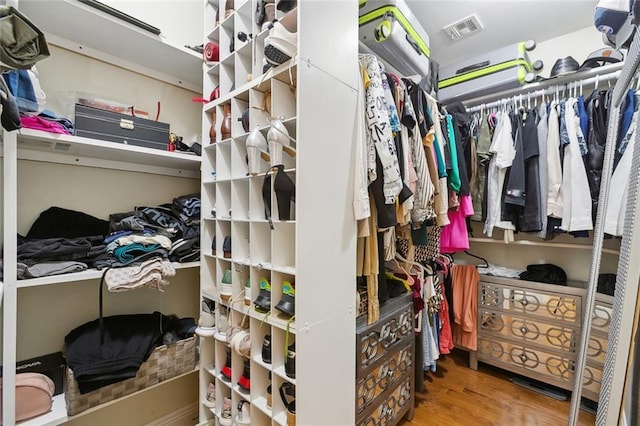 spacious closet featuring visible vents and wood finished floors