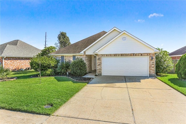 ranch-style home with a garage, driveway, a front lawn, and brick siding