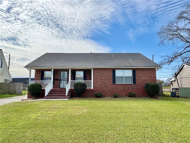 single story home with a front yard, covered porch, and brick siding