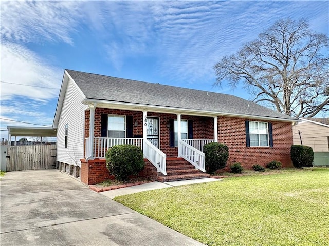 single story home featuring roof with shingles, a front yard, a porch, and brick siding