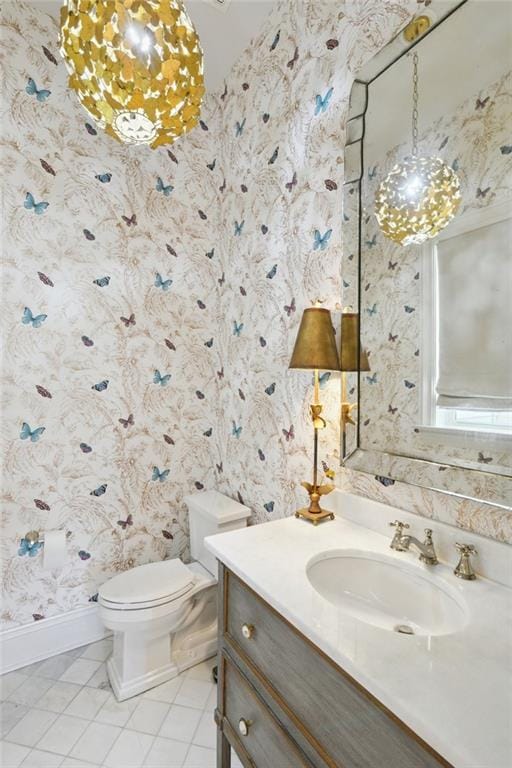 bathroom featuring tile patterned flooring, vanity, toilet, and wallpapered walls