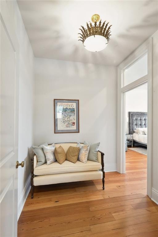 sitting room featuring baseboards and wood finished floors