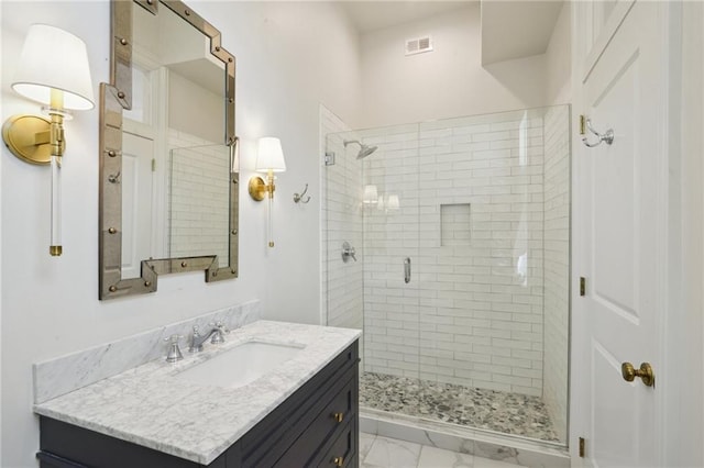 full bathroom featuring a stall shower, visible vents, and vanity