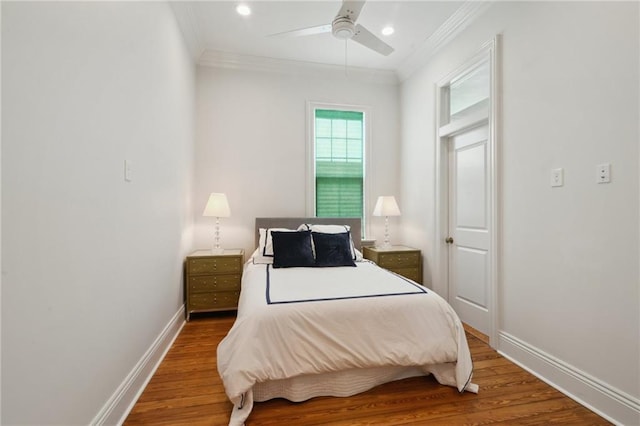 bedroom featuring a ceiling fan, baseboards, wood finished floors, and ornamental molding