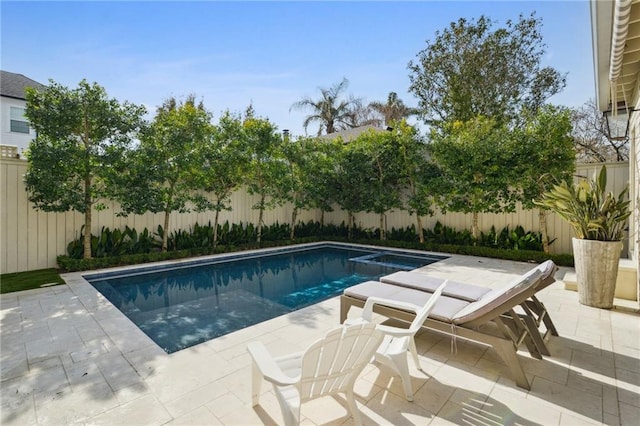 view of pool with a patio, a fenced backyard, and a pool with connected hot tub