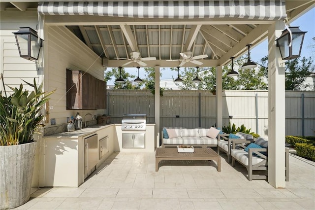 view of patio with a fenced backyard, a ceiling fan, an outdoor living space, and exterior kitchen