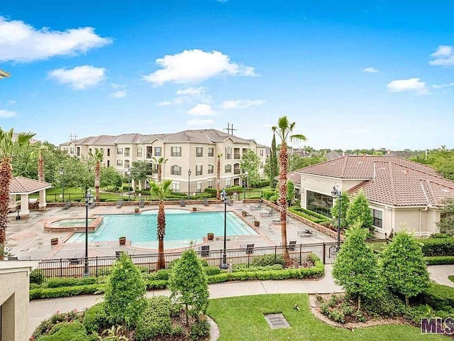 community pool featuring fence, a gazebo, and a patio