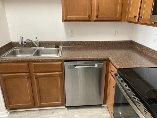 6765 Corporate Blvd Unit 2310, Baton Rouge, LA 70809 - kitchen featuring appliances with stainless steel finishes, dark countertops, and brown cabinetry