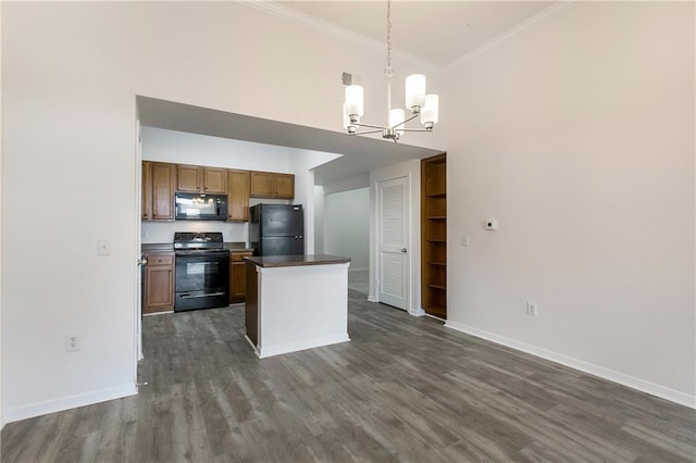 6765 Corporate Blvd Unit 2310, Baton Rouge, LA 70809 - kitchen with black appliances, a towering ceiling, a chandelier, dark wood-style flooring, and dark countertops