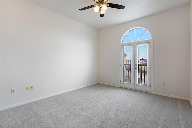 unfurnished room with a ceiling fan, carpet flooring, and baseboards