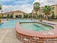 community pool featuring a hot tub