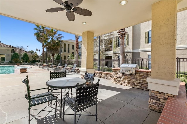 view of patio / terrace with area for grilling, grilling area, fence, and a community pool