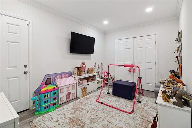 game room with ornamental molding, recessed lighting, and wood finished floors