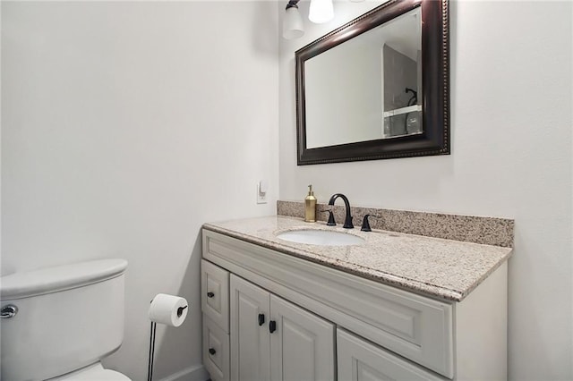 bathroom featuring vanity and toilet