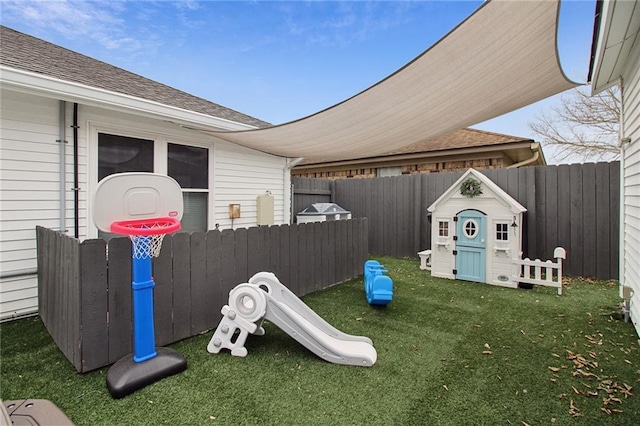 view of playground featuring a yard and fence