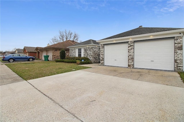 ranch-style house featuring a garage, driveway, stone siding, and a front yard