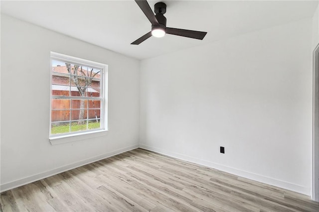 unfurnished room with light wood-type flooring, baseboards, and a ceiling fan