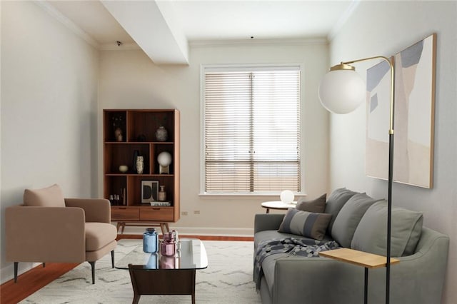 living area featuring wood finished floors, baseboards, and ornamental molding