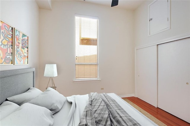 bedroom featuring a closet, wood finished floors, and a ceiling fan