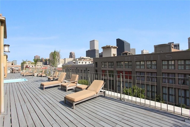 wooden deck featuring a view of city