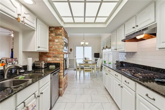 kitchen featuring white cabinetry and under cabinet range hood