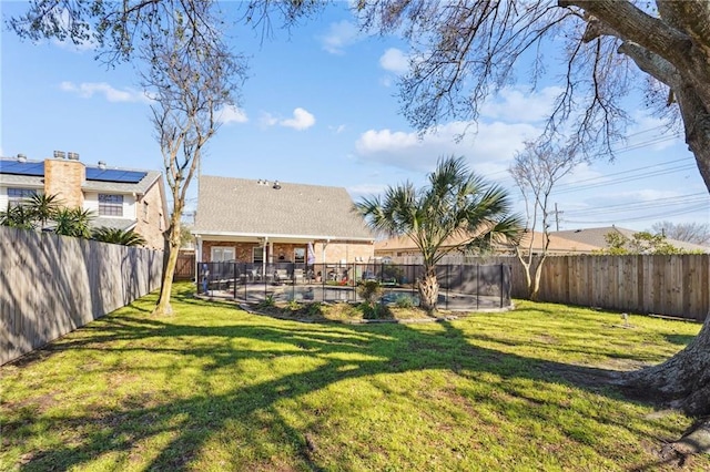 view of yard featuring a swimming pool and a fenced backyard